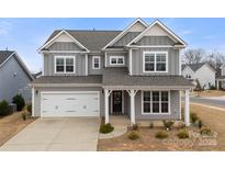 Charming two-story home with a welcoming front porch and attached two-car garage at 3041 Winged Teal Ct, Belmont, NC 28012