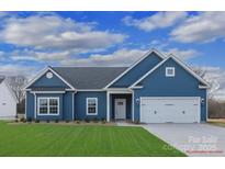 Stunning blue house with a two-car garage and well-manicured lawn at 3081 Meadowcrest Dr # 27, Clover, SC 29710