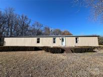 Single-wide mobile home with landscaping and a brick walkway at 3610 Becky Ln, Monroe, NC 28112