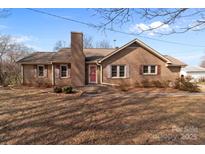 Charming brick home featuring a well-maintained yard and a classic brick chimney at 40503 Millingport Rd, Richfield, NC 28137