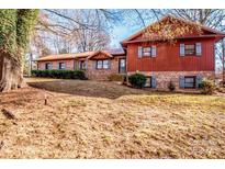 Ranch style home with brick and wood siding, situated on a large lot with mature trees at 5836 Grace Chapel Rd, Hickory, NC 28601