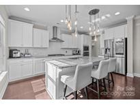 Modern kitchen with stainless steel appliances, granite counters, and island with bar seating at 840 Pecan Tree Ln, Fort Mill, SC 29715