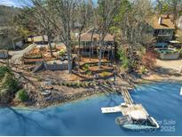 Charming waterfront home with a private dock, expansive deck, and lush landscaping at 1077 Gauguin Ln, Tega Cay, SC 29708