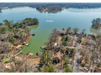 Beautiful aerial view of lakeside home with private docks on Lake Wylie in a wooded setting at 1077 Gauguin Ln, Tega Cay, SC 29708