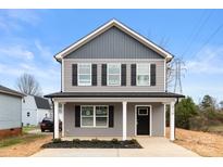 Two-story house with gray siding, black shutters, and a front porch at 204 N Yadkin Ave, Spencer, NC 28150