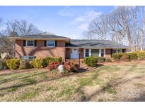 Brick ranch house with mature trees and landscaping at 220 Augusta Dr, Statesville, NC 28625