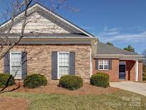 Brick front exterior of charming ranch home with stone accents and landscaping at 4026 Saint James Way # 1, Monroe, NC 28110