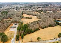 Aerial view of house and 26 acres of land, including a pond at 4816 Zion Church Rd, Concord, NC 28025