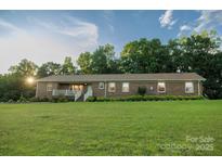 Charming one-story brick home featuring a well-maintained lawn and inviting front porch at 4816 Zion Church Rd, Concord, NC 28025