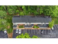 An aerial view of the condo building, parking, and the surrounding trees at 5929 Quail Hollow Rd # B, Charlotte, NC 28210