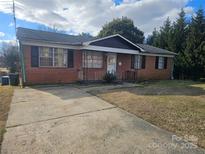 Brick ranch house with a paved driveway and a spacious yard at 605 E Horah St, Salisbury, NC 28144