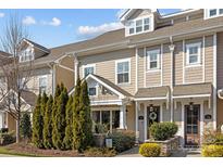 Charming townhome showcases manicured landscaping and a welcoming entrance with a wreath on the front door at 736 Amalfi Dr, Davidson, NC 28036