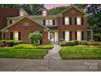 Charming brick home featuring a well-manicured lawn, dark shutters, and a welcoming walkway at 9108 Nolley Ct # B, Charlotte, NC 28270