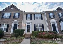 Brick front exterior of charming townhome with landscaping at 10946 Garden Oaks Ln, Charlotte, NC 28273