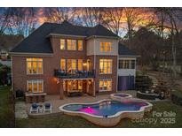 Stunning backyard with a pool, patio, balcony, outdoor seating, and beautiful sunset views at 162 Wild Harbor Rd, Mooresville, NC 28117