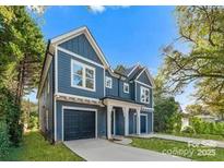 Two-story blue house with a two-car garage and landscaped yard at 2149 Highland St, Charlotte, NC 28208