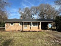 Brick ranch house with covered porch and carport at 226 Bradley Farm Rd, Statesville, NC 28625