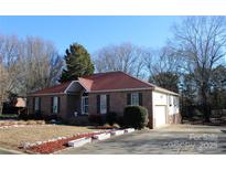 Charming brick home featuring manicured landscaping, a driveway, and an attached garage at 3447 Nesting Ln, Fort Mill, SC 29708