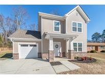 Two-story house with brick accents and a white door at 3714 Small Ave, Charlotte, NC 28269