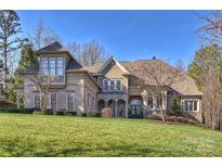 Stunning two-story home featuring a lush lawn and well-manicured landscaping at 4004 Blossom Hill Dr, Matthews, NC 28104