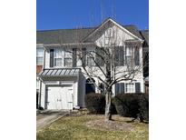 Two-story townhome with attached garage, landscaping, and a tree in front at 6019 Queens Walk Ct, Indian Land, SC 29707