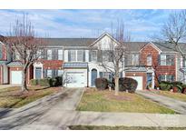 Inviting townhome with a blend of brick and siding, featuring a one-car garage and well-maintained landscaping at 6019 Queens Walk Ct, Fort Mill, SC 29707