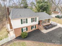 Charming two-story home with landscaped yard and inviting covered front porch at 8025 Cliffside Dr, Charlotte, NC 28270