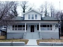 Charming two-story home with a inviting front porch and manicured lawn at 105 N Inman Ave, Bessemer City, NC 28016