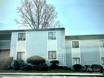 Charming light blue two-story condo with well-maintained landscaping at 10933 Harrowfield Rd, Charlotte, NC 28226