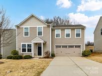 Charming two-story home featuring a two-car garage and well-manicured lawn at 1128 Tangle Ridge Se Dr, Concord, NC 28025