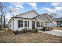 Charming single-story home with vinyl siding, dark shutters, and a welcoming front porch at 1140 Roberts St, China Grove, NC 28023