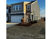 Two-story home with gray siding, two-car garage, and landscaped lawn at 343 Embers Ln, Clover, SC 29710