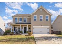 Charming two-story home featuring a welcoming front porch and a two-car garage at 4442 Golden View Dr, Charlotte, NC 28278