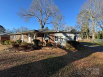 Brick ranch home with a sunroom and a deck in the backyard at 518 Glenn St, Chester, SC 29706