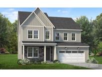 Two-story house with gray siding, stone accents, and a two-car garage at 7120 Wayfarer Dr # 0079, Charlotte, NC 28269