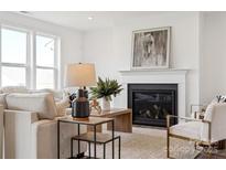 Bright living room features a cozy fireplace, plush seating, and stylish decor accents at 7120 Wayfarer Dr # 0079, Charlotte, NC 28269