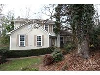 Charming two-story home featuring large windows, shutter details, and well-maintained landscaping at 8203 Brynmar Dr, Charlotte, NC 28270