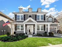 Two-story house with gray siding, white trim, and a covered porch at 11317 Trailside Nw Rd, Huntersville, NC 28078