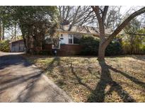 Brick ranch home with mature trees and a spacious yard at 1138 Norland Rd, Charlotte, NC 28205