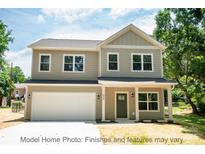 Two-story Craftsman style home with a large front yard and attached garage at 116 Durham Rd, Stanley, NC 28164