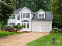 Charming two-story home with a manicured lawn, two-car garage, and beautiful landscaping at 172 Foxtail Dr, Mooresville, NC 28117