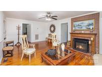 Living room featuring hardwood floors, fireplace and seating area at 202 W Main St, Cherryville, NC 28021