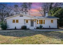 Charming single-story home boasts a well-maintained yard and neutral-colored brick at 2624 Ashley Rd, Charlotte, NC 28208