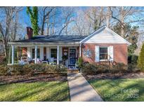 Brick ranch house with covered porch and landscaped yard at 303 Edgewood Rd, Shelby, NC 28150