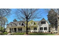 Charming white brick home featuring black shutters and a manicured front yard, exuding classic elegance at 357 Magnolia St, Davidson, NC 28036