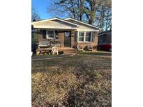 Brick ranch house with covered porch, mature trees, and a well-maintained lawn at 453 Bynum Ave, Rock Hill, SC 29732