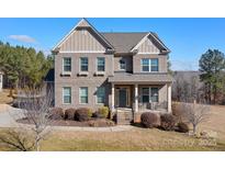 Two-story brick home with a large front porch and landscaped yard at 6361 Willow Farm Dr, Denver, NC 28037