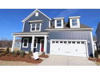 Two-story house with blue siding, white trim, and a two-car garage at 8224 Annsborough Nw Dr, Concord, NC 28027