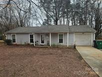 Ranch style home with attached garage and landscaping at 9012 Bremerton Ct, Charlotte, NC 28227