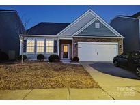 Charming single-Gathering home featuring stone accents, a two-car garage, and a well-maintained front yard at 164 N Cromwell Dr, Mooresville, NC 28115